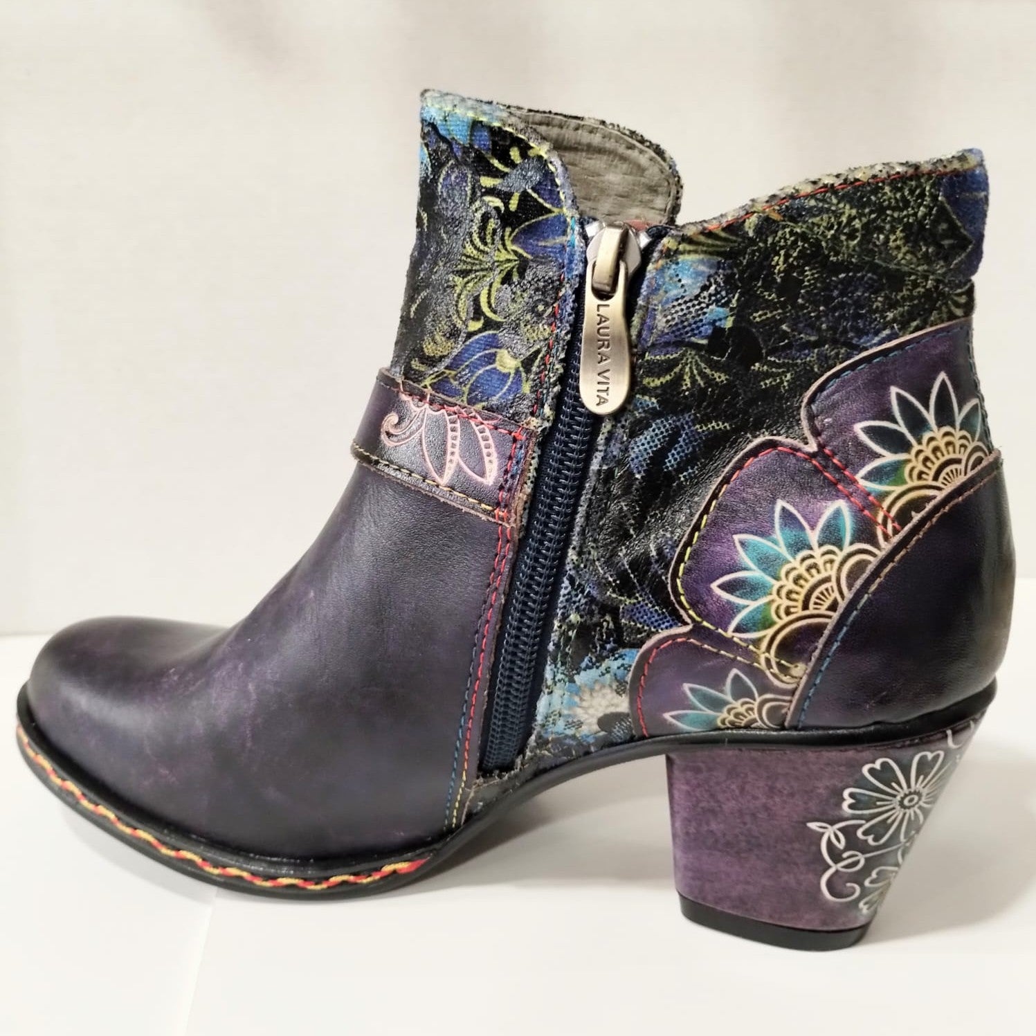 Colorful patterned ankle boot with a zipper on a light background